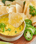 Farmer Foodie Golden Chedda Cashew Parm mixed with hot water into a deliciously creamy vegan queso dip.