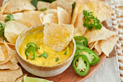 Farmer Foodie Golden Chedda Cashew Parm mixed with hot water into a deliciously creamy vegan queso dip.